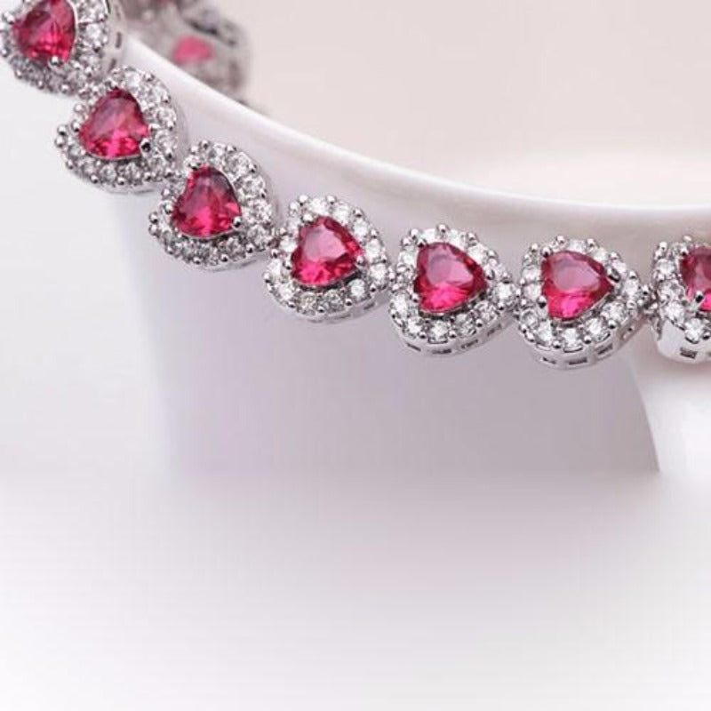 Royal Rhodium Plated Bracelet Encrusted With Red Shiny Heart Shaped Zircon Stones For Women