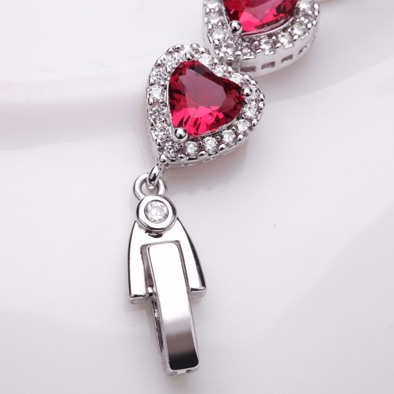 Royal Rhodium Plated Bracelet Encrusted With Red Shiny Heart Shaped Zircon Stones For Women