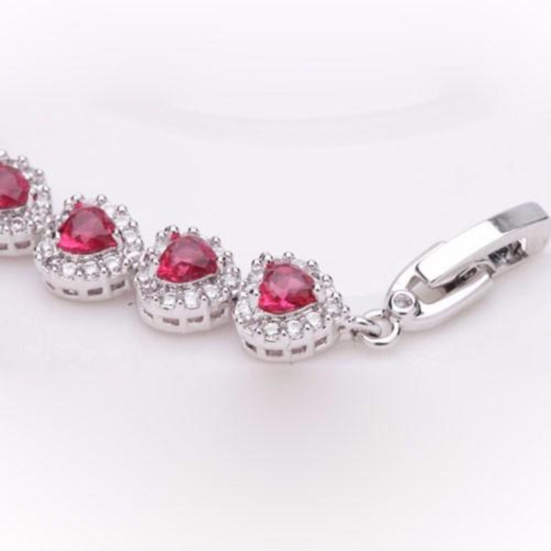 Royal Rhodium Plated Bracelet Encrusted With Red Shiny Heart Shaped Zircon Stones For Women